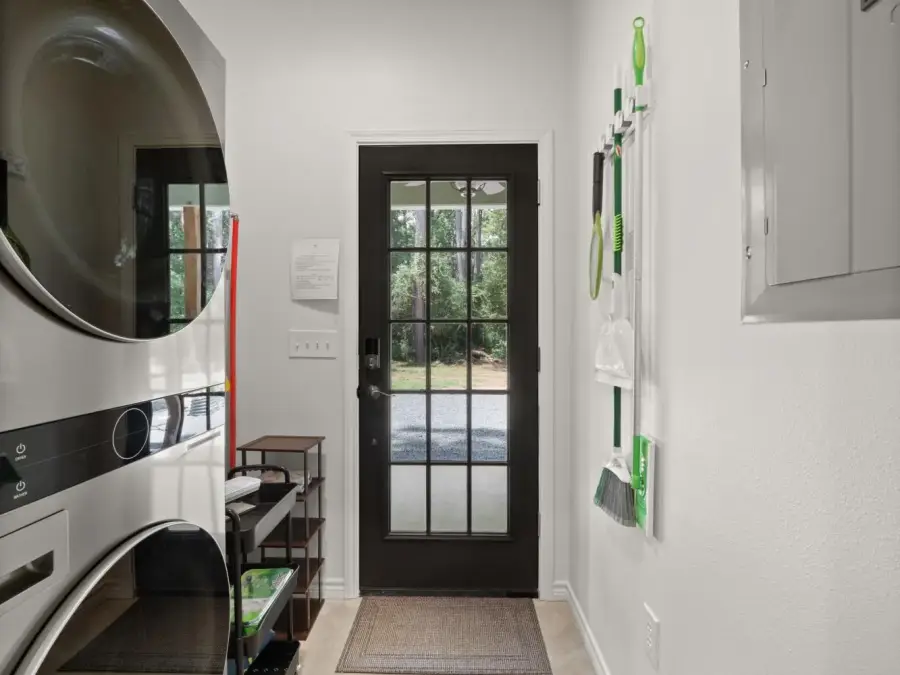 Before the back door is a full sized stackable washer and dryer. Before the back door is a full sized stackable washer and dryer.